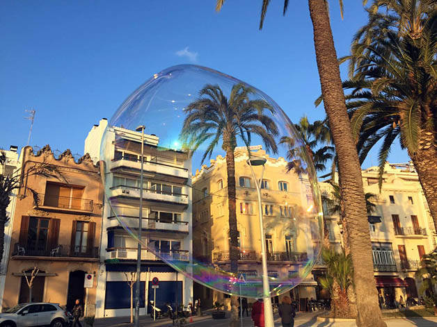 sitges and palm tree in soap bubble